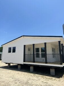 A white doublewide with a black deck