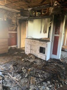 A burned bedroom with a burned dresser