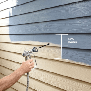 A paint gun spray painting mobile home siding