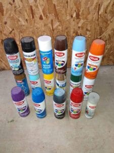 A lot of paint spray cans in all different colors