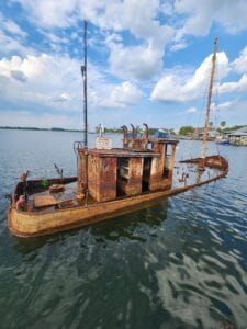 A tug boat sinking into the water