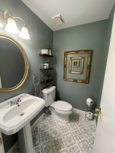A light green bathroom with white fixtures