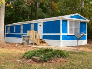 A very bright blue painted mobile home