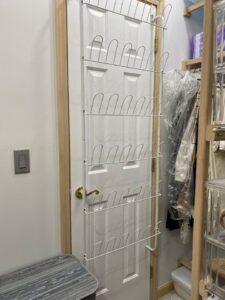 A door to a closet with a shoe rack on it