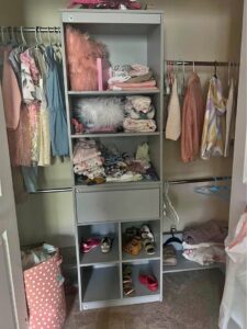 A well organized closet with clothes hanging