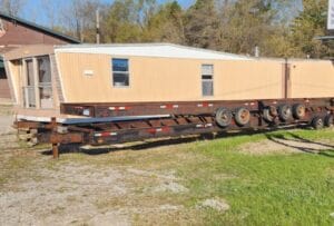 A large mobile home frame with wheels