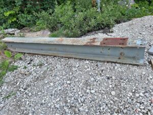 A steel i beam laying on the ground