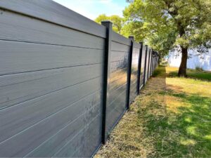 A large gray fence with solid panels