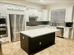 A large kitchen with stainless appliances