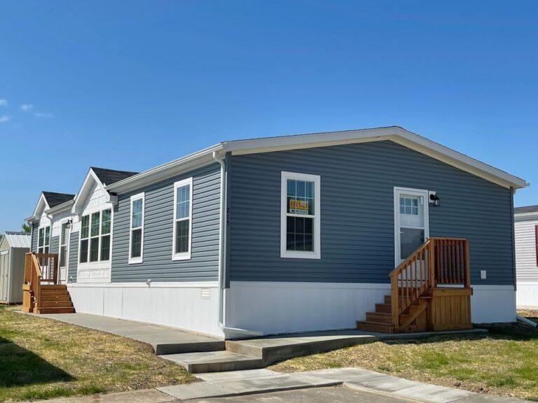 A large gray doublewide that is very clean with gray siding
