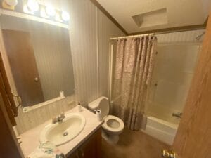 A large bathroom with a sink toilet and shower