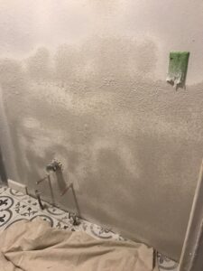 A bathroom wall that is textured and ready to paint