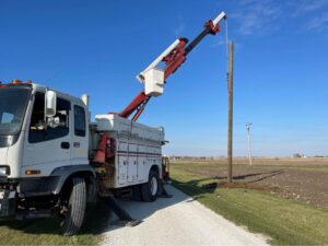 A crane truck installing a power pole