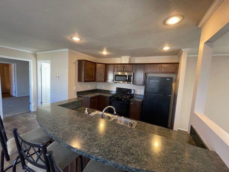 A kitchen with canned lighting in a mobile home