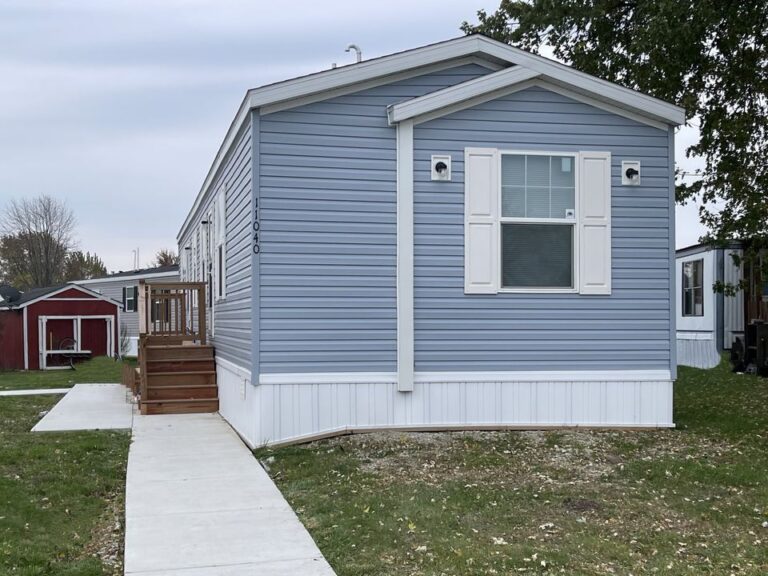 A beautiful baby blue singlewide with white trim