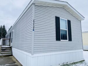 A gray singlewide with black shutters