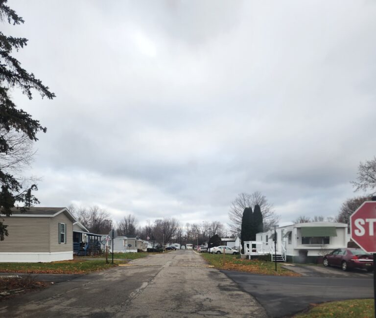 A mobile home park with a paved drive