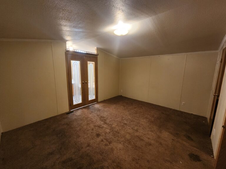 A large bedroom in a triple wide manufactured home