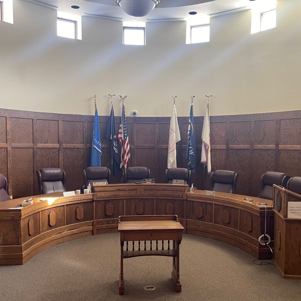 The inside of a courtroom with flags hanging
