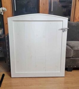 A white dutch door sitting on a wooden floor