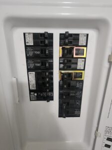 A breaker box in a mobile home with breakers showing