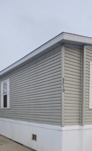 A gray colored doublewide with white trim