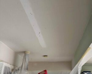 A drywalled ceiling being repaired from water damage