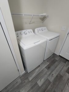 A set of washers and dryers in a laundry area