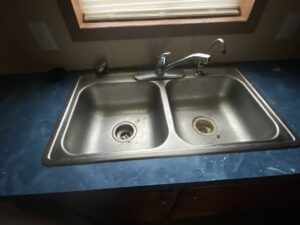 A double stainless steel sink in a kitchen