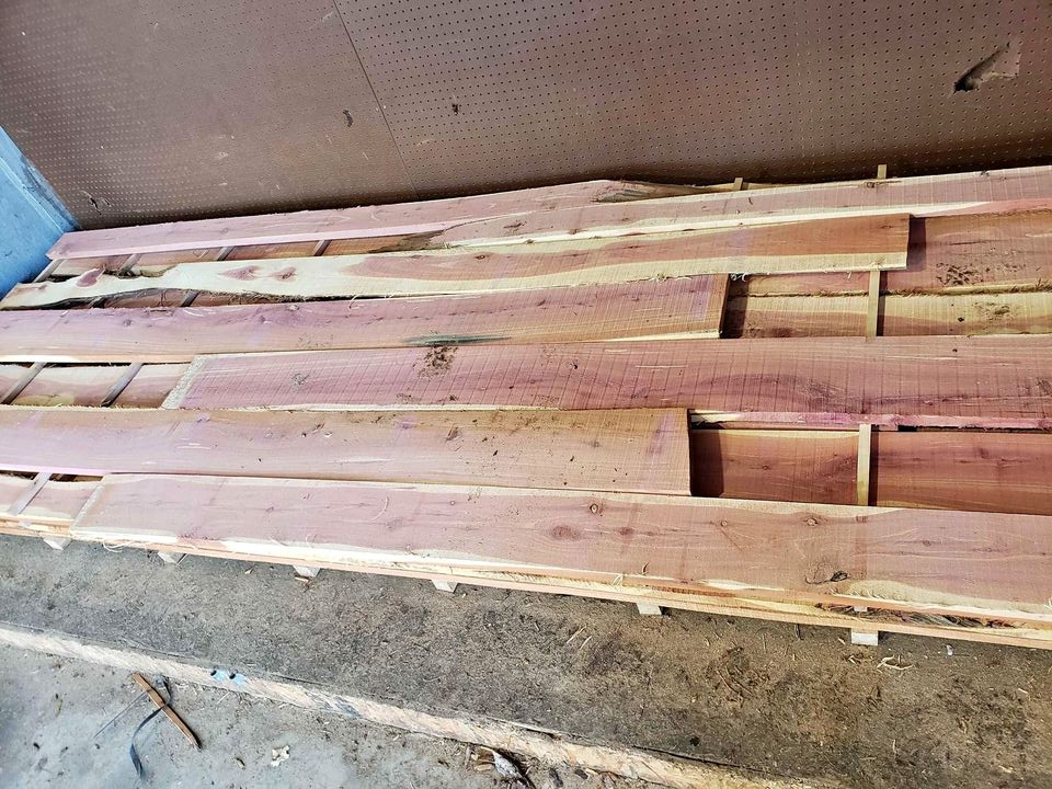 A stack of cedar siding laying on the ground