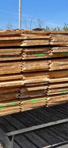 A stack of cedar siding sitting on a trailer