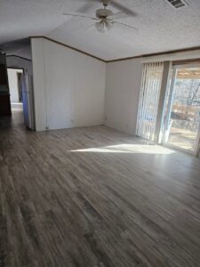 The living room area of a singlewide with new tile flooring