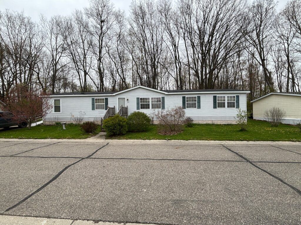 A white doublewide with black shutters