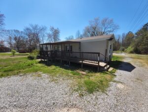 A wooden porch added to a mobile home side