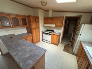 A large kitchen in a moblie home with appliances