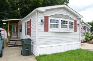 A gray singlewide with red shutters