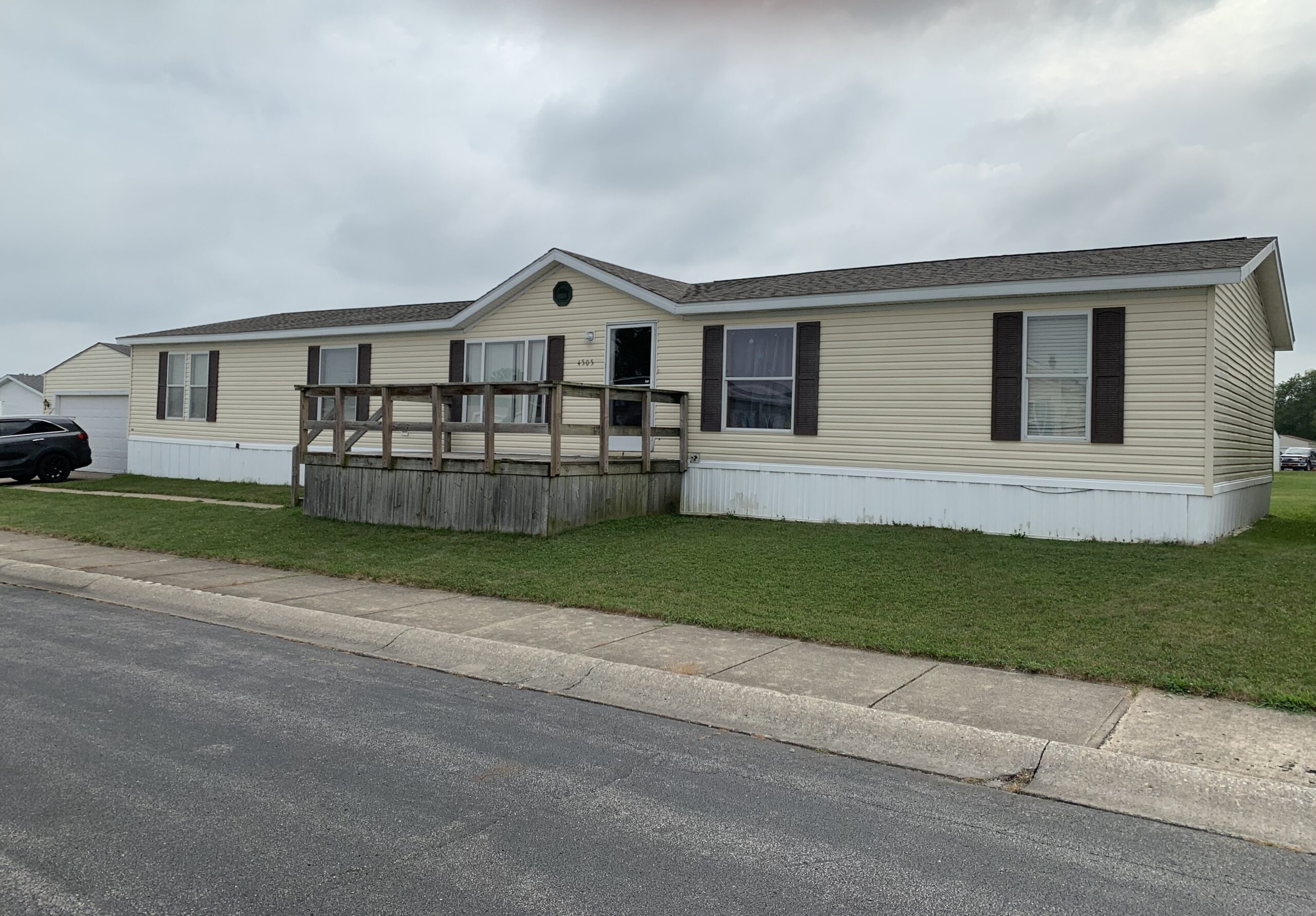 We Buy Mobile Homes Fast Cash - Ohio Indiana Michigan Beige manufactured home with deck purchased for cash by experienced mobile home buyers in Ohio