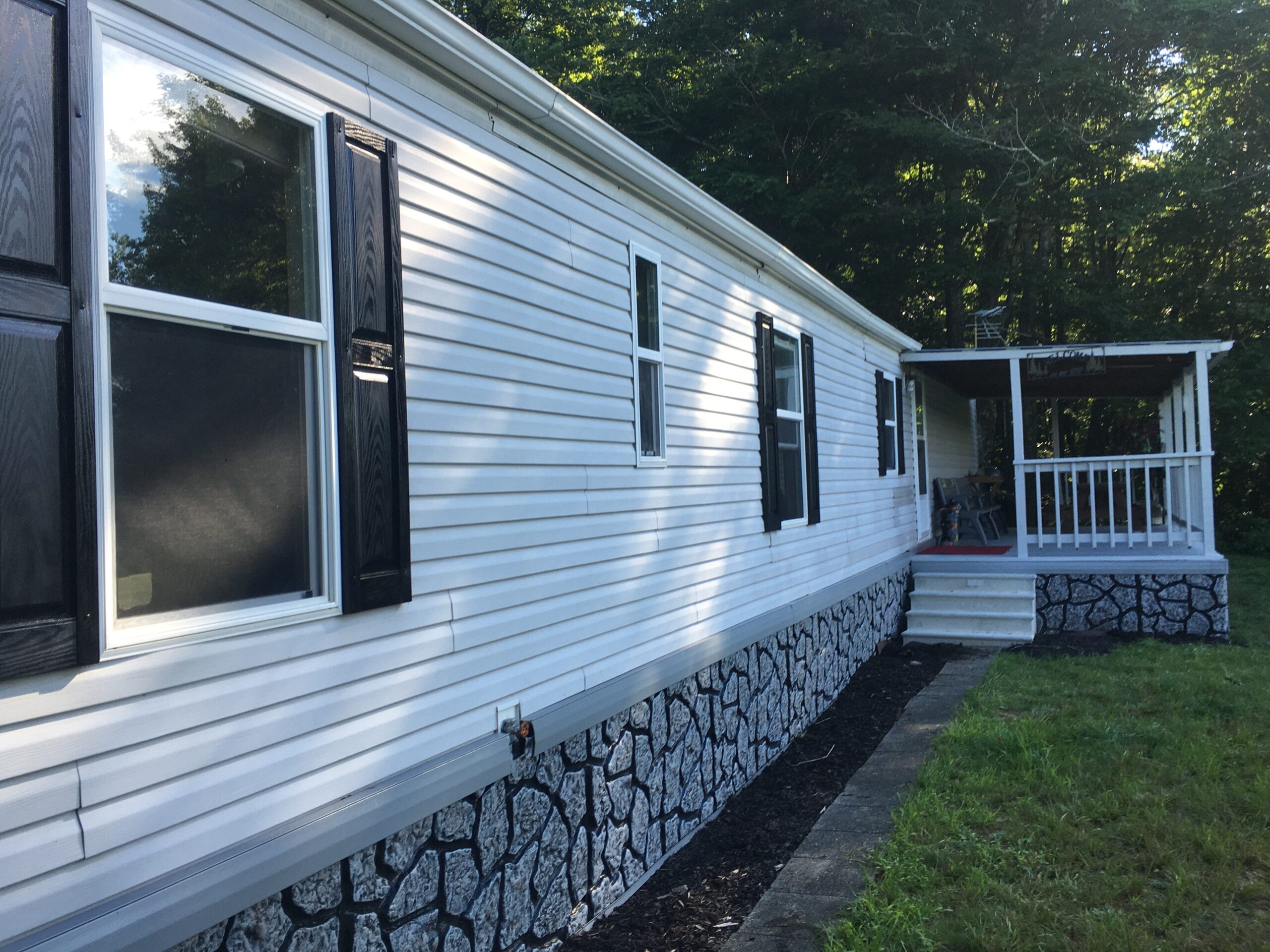 Mobile Home Buyers - Updated Homes Welcome Well-maintained mobile home with stone skirting and deck purchased by professional cash buyers
